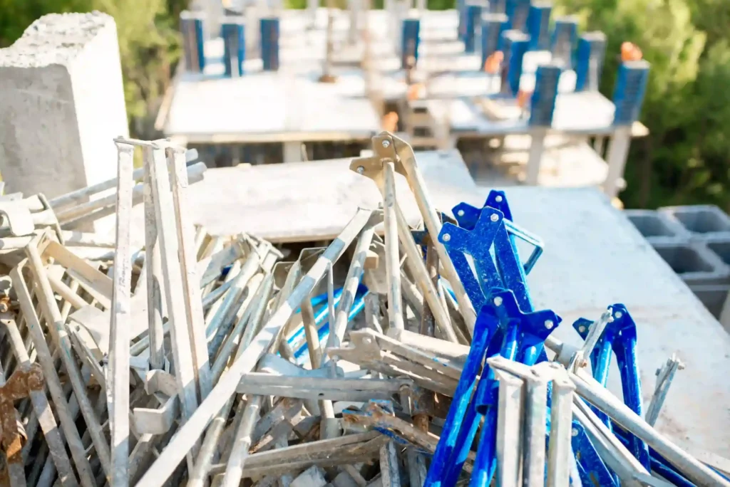 Pile of construction debris including metal parts and concrete, showcasing debris removal services and same day junk removal