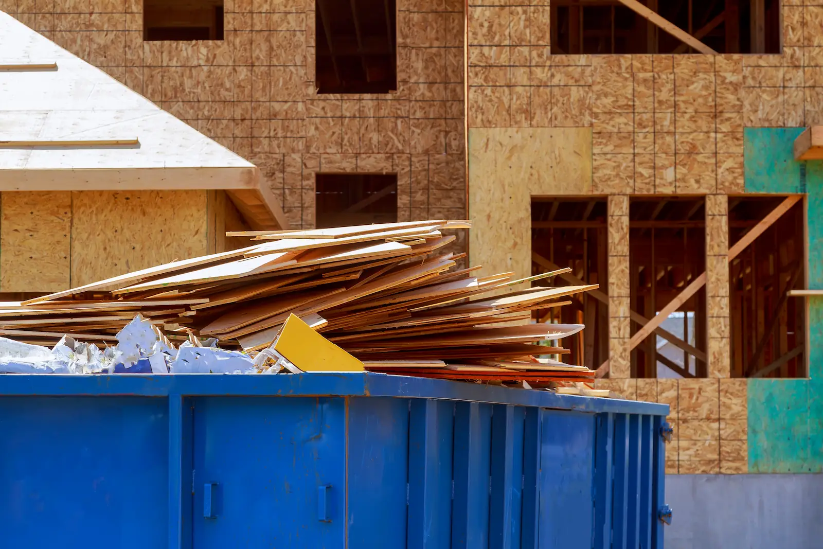 Stacked wooden planks at a construction site - construction debris removal, construction junk removal in New York