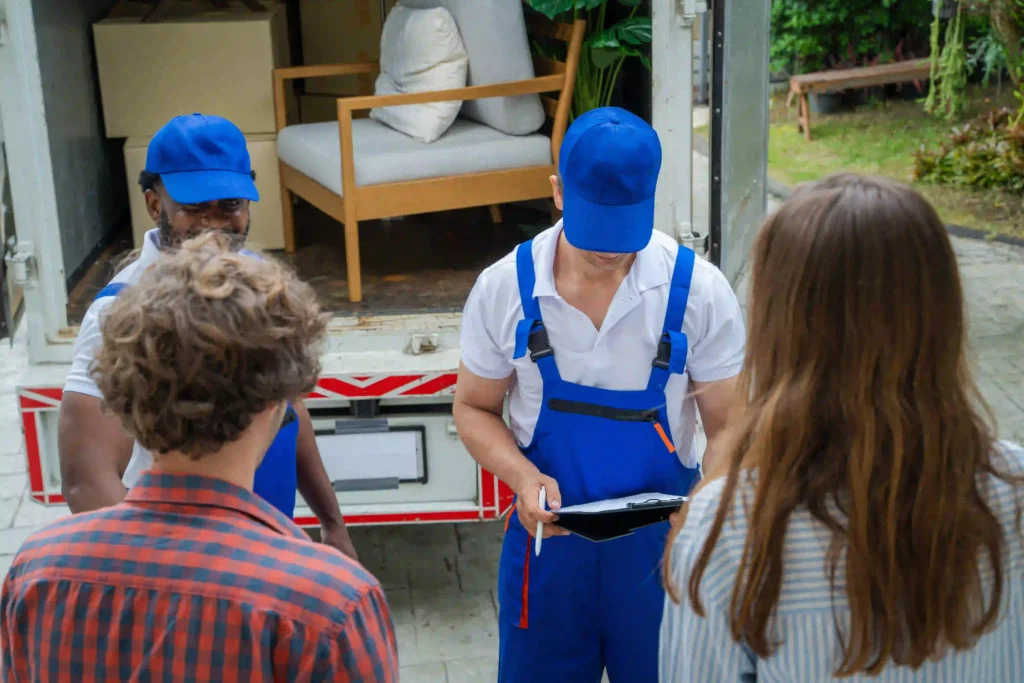 Two individuals in blue uniforms confirming that all junk is removed from an office - junk removal NYC, office junk removal