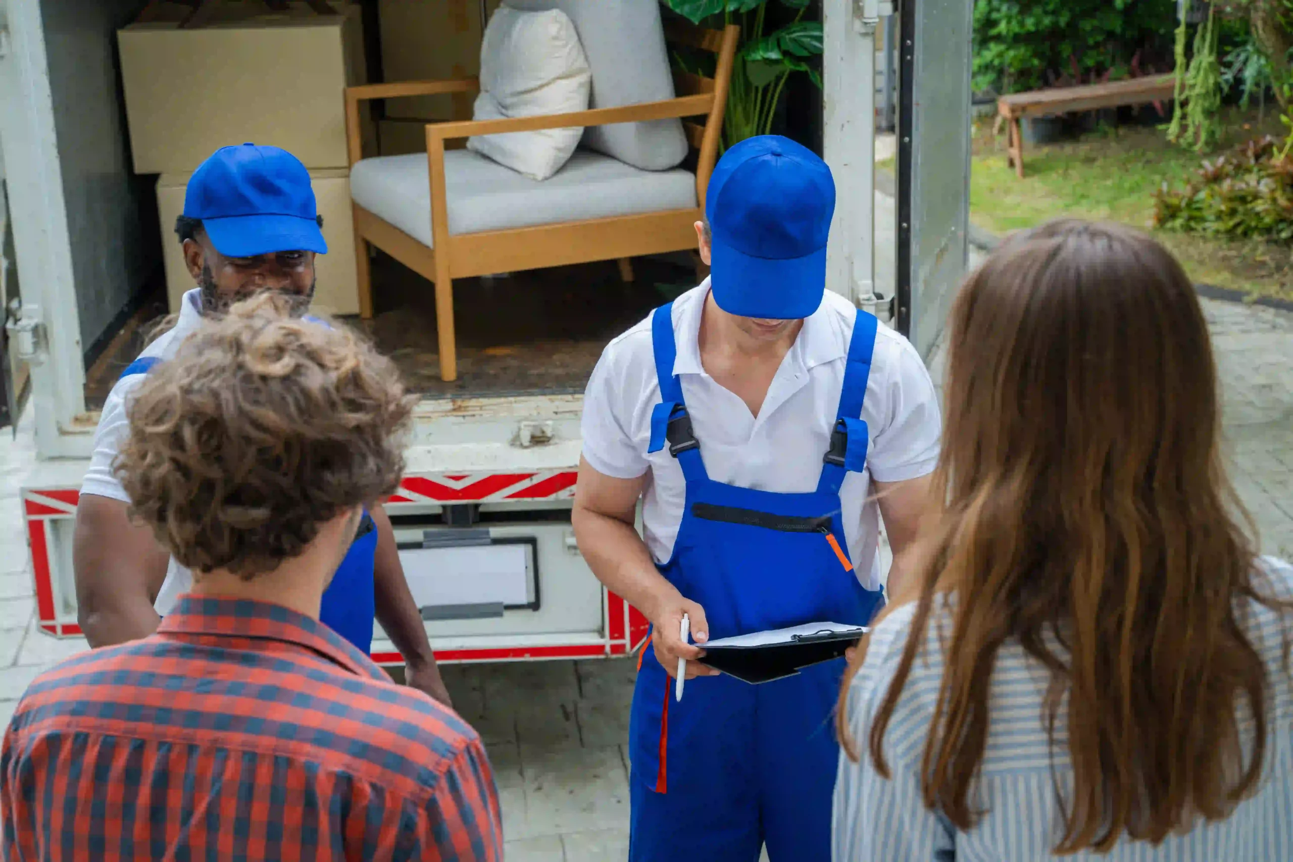 Two individuals in blue uniforms confirming that all junk is removed from an office - junk removal NYC, office junk removal